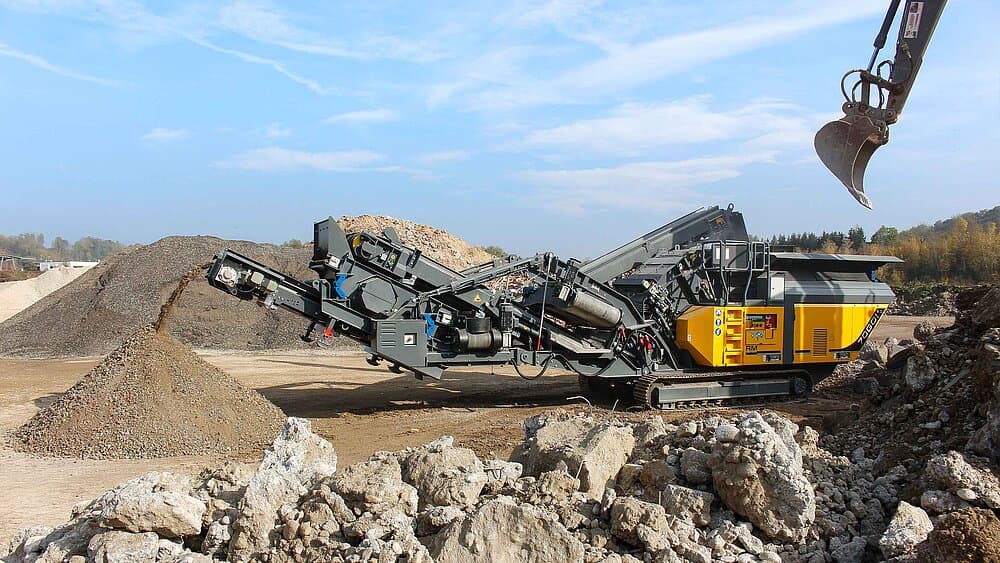 Demolition concrete being processed for reuse on a Brisbane site instead of being disposed of at a tip